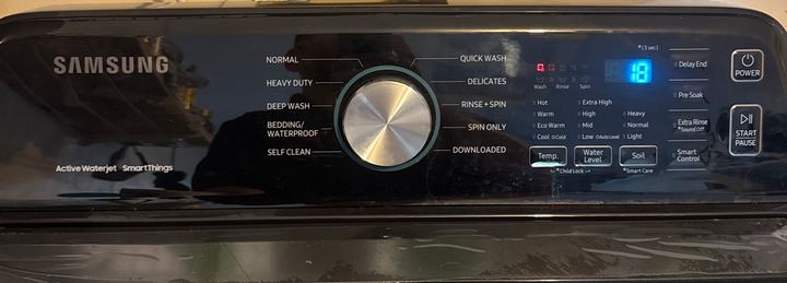 Samsung top-load washer control panel with cycle selector knob and digital display